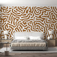 Abstract geometric wallpaper creating a modern focal point in a minimalist living room with natural lighting