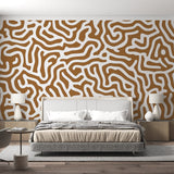 Abstract geometric wallpaper creating a modern focal point in a minimalist living room with natural lighting