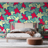 Modern abstract wallpaper with red and teal organic shapes creating a bold statement in a minimalist living room