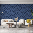 Modern abstract navy blue wallpaper in a minimalist living room setting with white furniture and natural light