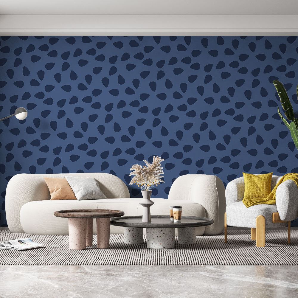 Modern abstract navy blue wallpaper in a minimalist living room setting with white furniture and natural light