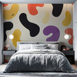 Modern abstract wallpaper with organic shapes bringing bold color and movement to a minimalist living room setting