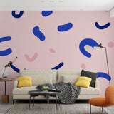 Modern pink and blue abstract wallpaper creating a bold statement wall in a minimalist living room with natural light