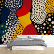 Modern abstract polka dot wallpaper bringing life to a bright living room with navy and red accents