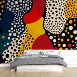 Modern abstract polka dot wallpaper bringing life to a bright living room with navy and red accents