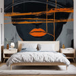 Modern abstract portrait wallpaper creating a bold statement in a minimalist living room with grey furniture and orange accents
