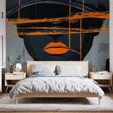 Modern abstract portrait wallpaper creating a bold statement in a minimalist living room with grey furniture and orange accents