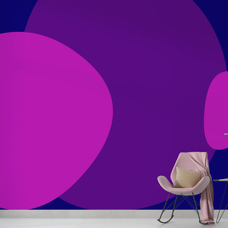 Modern purple circles abstract wallpaper mural styled in a minimalist living room with grey sofa and metal accents