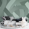 Modern geometric wallpaper in sage green showcased in a minimalist living room with natural light