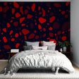 Modern terrazzo pattern wallpaper in striking red and navy displayed in a minimalist living room setting