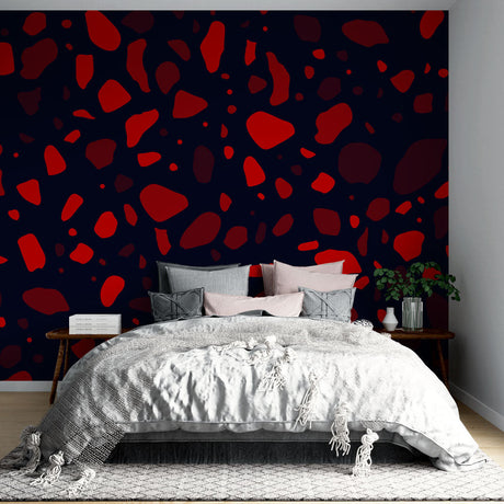 Modern terrazzo pattern wallpaper in striking red and navy displayed in a minimalist living room setting