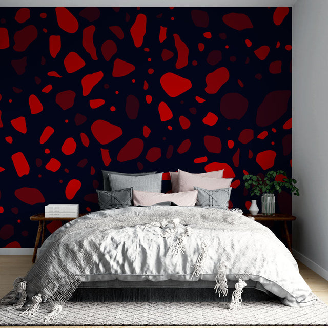 Modern terrazzo pattern wallpaper in striking red and navy displayed in a minimalist living room setting