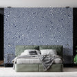 Navy blue geometric wallpaper creating a stunning focal point in a modern living room with clean furniture and natural light