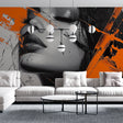Modern portrait wallpaper with orange and black design styled in a contemporary living room with minimal furniture