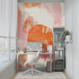 Abstract orange and pink brushstroke wallpaper in a bright modern living room setting