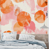 Home studio featuring bold abstract wallpaper with orange and pink brushstrokes