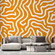 Orange geometric abstract wallpaper mural showcased in a modern living room with white furniture and natural light
