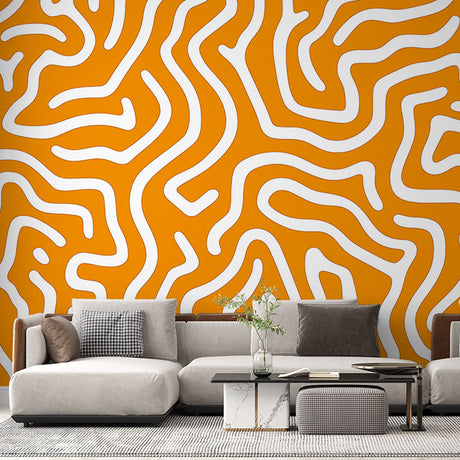 Orange geometric abstract wallpaper mural showcased in a modern living room with white furniture and natural light