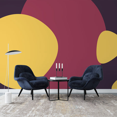 Abstract circle wallpaper in yellow and burgundy tones creating a modern statement wall in a bright living room setting