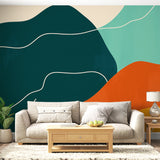 Modern abstract wallpaper with green and orange curves shown in a bright living room setting with minimalist furniture