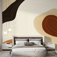 Modern abstract wallpaper with organic curves in terracotta and beige tones creating a warm atmosphere in a minimalist living room
