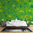 Green terrazzo abstract wallpaper in a bright modern living room, showing how the organic pattern creates a fresh, natural atmosphere