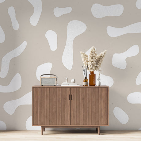 Abstract organic shapes wallpaper creating a calm atmosphere in a modern living room with minimal furniture