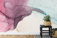 Pink and mint abstract watercolor wallpaper in a modern living room with natural light