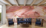 Master bedroom with pink marble accent wall, gold details create warm morning glow