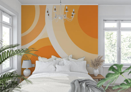 Orange geometric circle wallpaper in modern living room with grey sofa and natural light