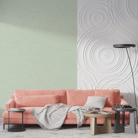 Sage green textured wallpaper in modern living room with natural light highlighting surface details