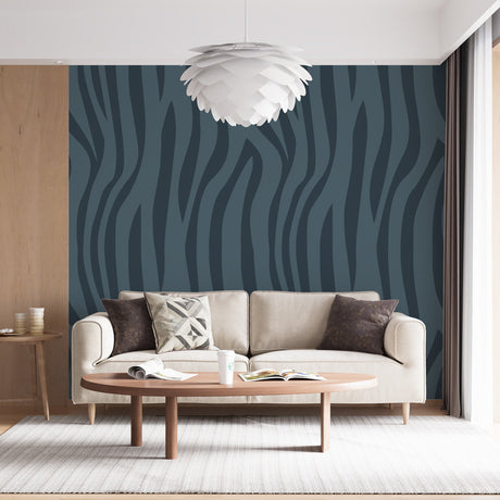 Modern teal wave wallpaper creating movement in a bright contemporary living room with minimalist furniture