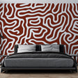 Modern geometric abstract wallpaper in terracotta tones creating a stunning focal point in a minimalist living room