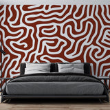 Modern geometric abstract wallpaper in terracotta tones creating a stunning focal point in a minimalist living room