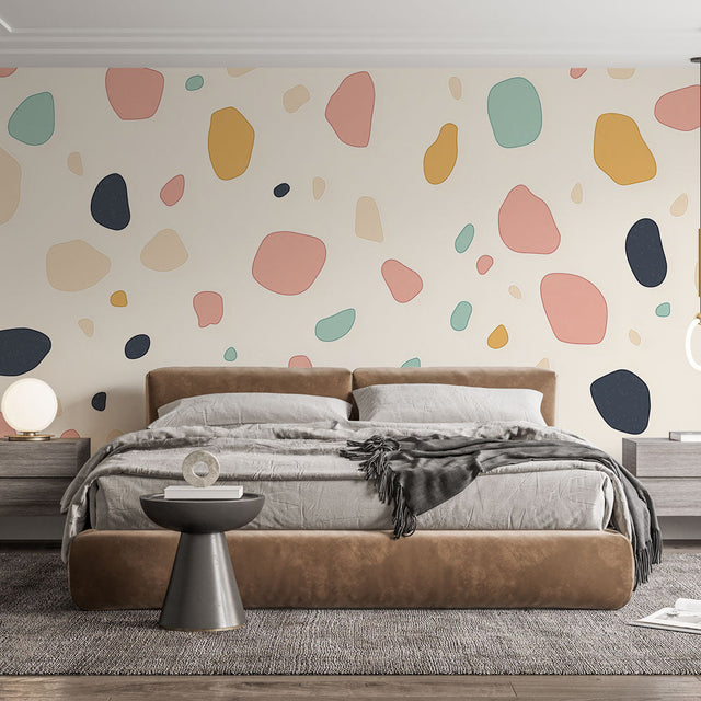 Abstract terrazzo wallpaper in soft pastels creating a modern look in a bright living room with minimal furniture