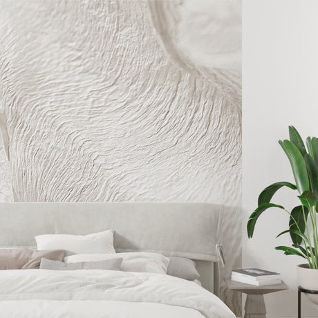 Modern living room featuring beige wave pattern wallpaper with natural lighting highlighting textured details