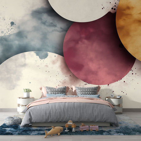 Abstract watercolor circle wallpaper in pink and gold creating a soft, dreamy atmosphere in a modern living room setting