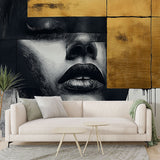 Abstract portrait wallpaper in black and gold creating dramatic impact in a modern living room with minimal furniture