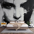 Abstract portrait wallpaper creating a dramatic focal point in a modern living room with minimal furniture
