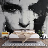 Abstract portrait wallpaper creating a dramatic focal point in a modern living room with minimal furniture