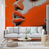 Street art portrait wallpaper creating modern impact in a bright living room with orange accents and minimalist furniture