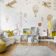 Adventure wallpaper with hot air balloons and planes bringing magic to a bright nursery with natural light