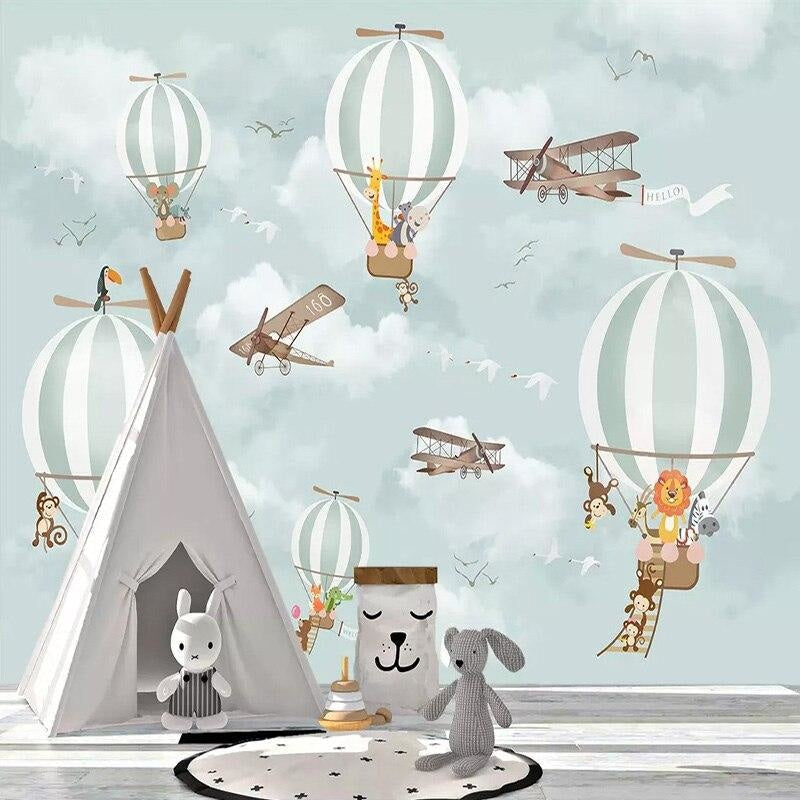 Nursery wall with animal hot air balloon mural in soft daylight