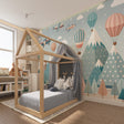 Hot air balloon wallpaper creating magic in a bright nursery with mountain views and floating pastel balloons