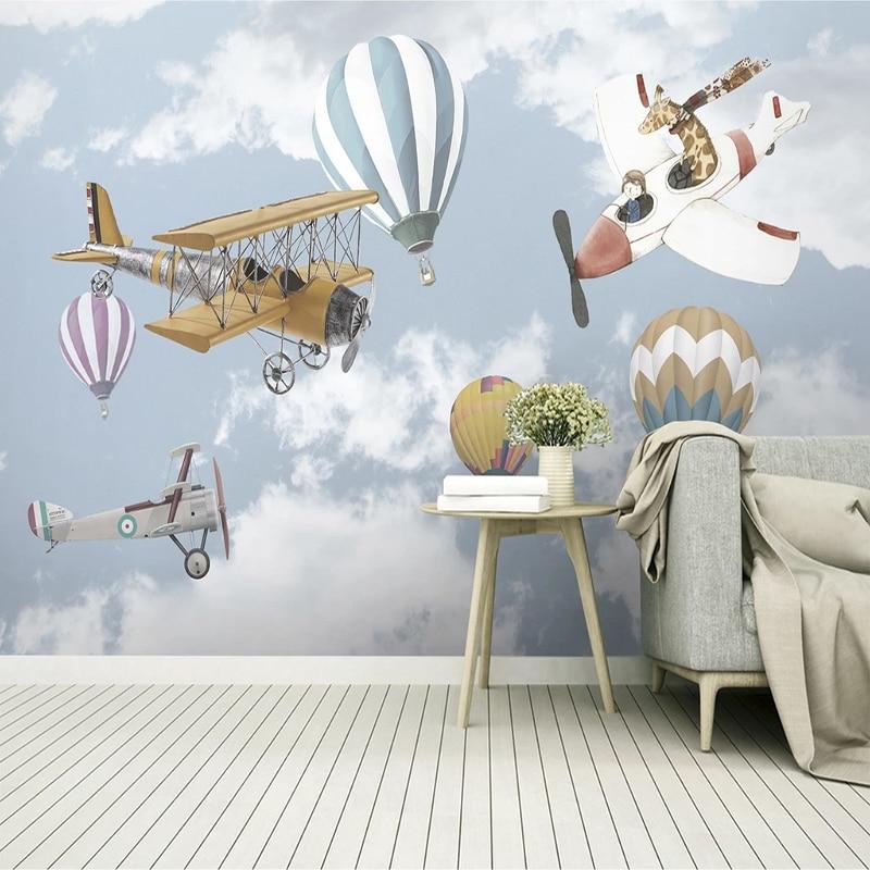 Baby room with aviation adventure wallpaper showing gentle sky scenes and whimsical aircraft