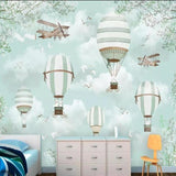 Hot air balloon mural transforming a baby's room into a gentle adventure space