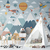 Mountain adventure wallpaper featuring airplanes in a cozy kids bedroom with natural light