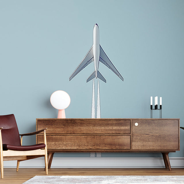 Modern airplane wallpaper mural showcased in a bright kid's bedroom with white furniture and blue accents
