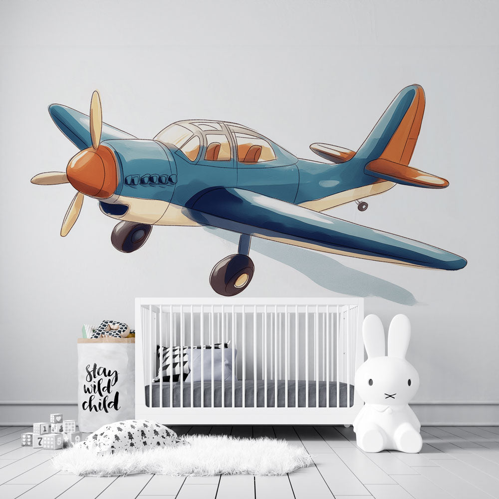 Vintage airplane wallpaper in blue and orange tones creating a cozy atmosphere in a modern nursery