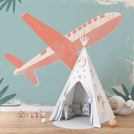 Airplane Mural Wallpaper with coral aircraft and tropical leaves bringing adventure to a modern nursery setting